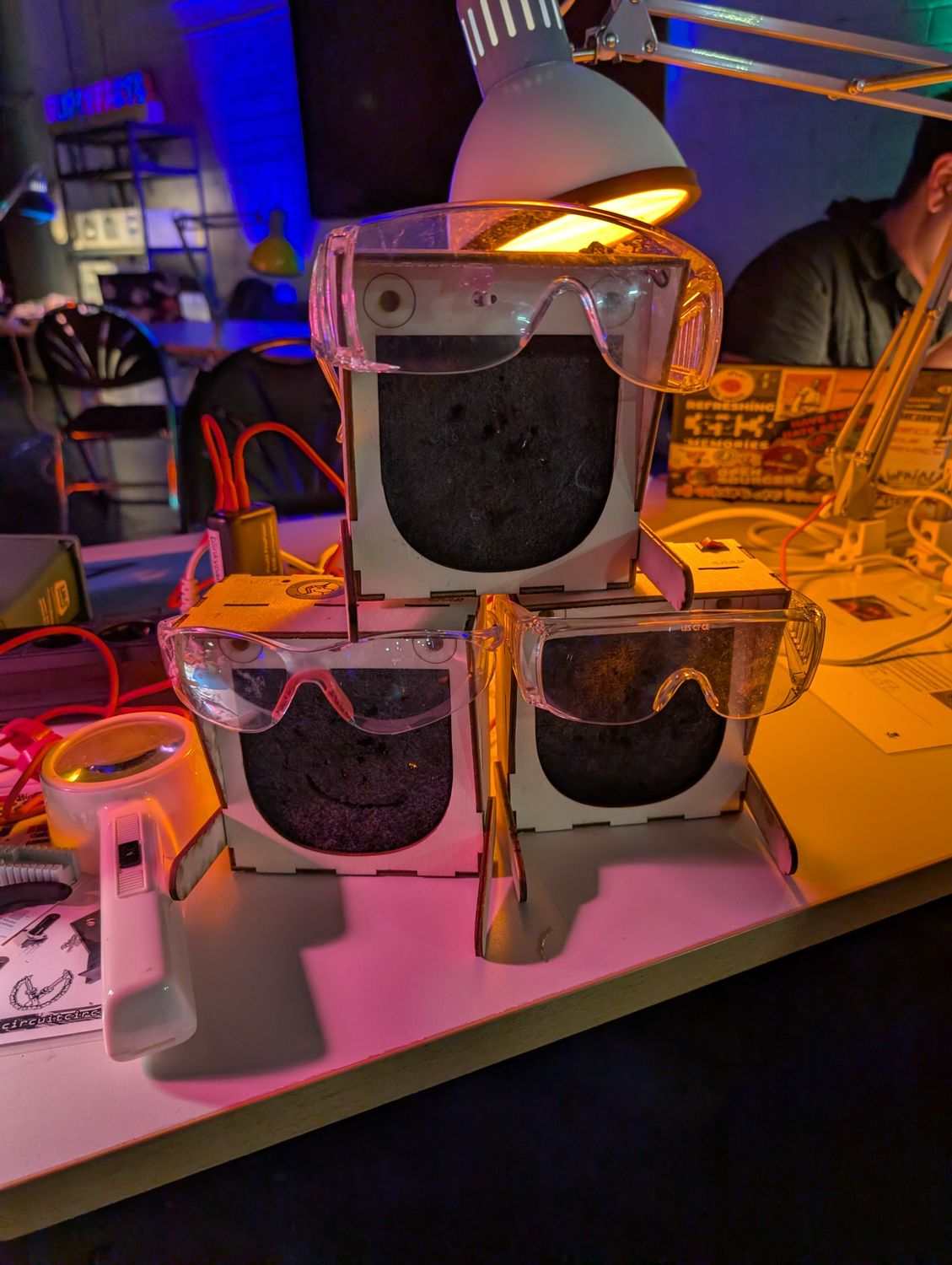 Drei Humos (Ablüfter), die jeweils eine Schutzbrille tragen